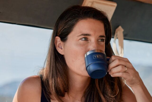 Lifestyle image of a woman drinking from YETI Rambler 6 OZ Espresso Mug - Navy